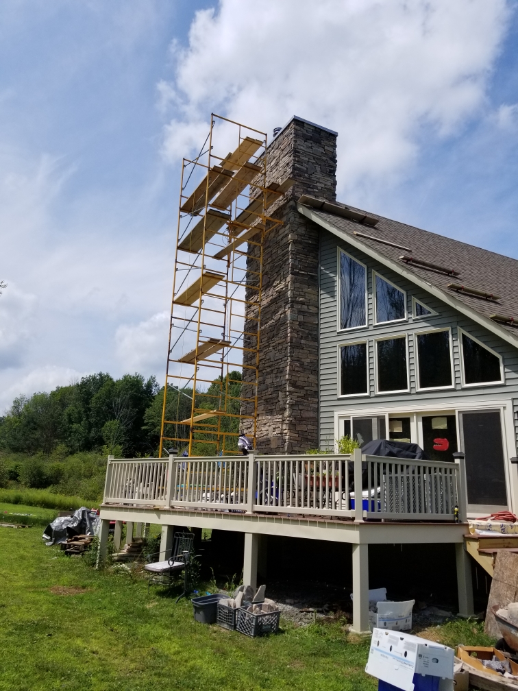 Expert cultured stone chimney installation featuring custom stonework and precision masonry by Bob Brislin Construction